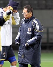ネックウオーマーをかぶる平山。右は岡田監督(撮影・鹿野芳博)